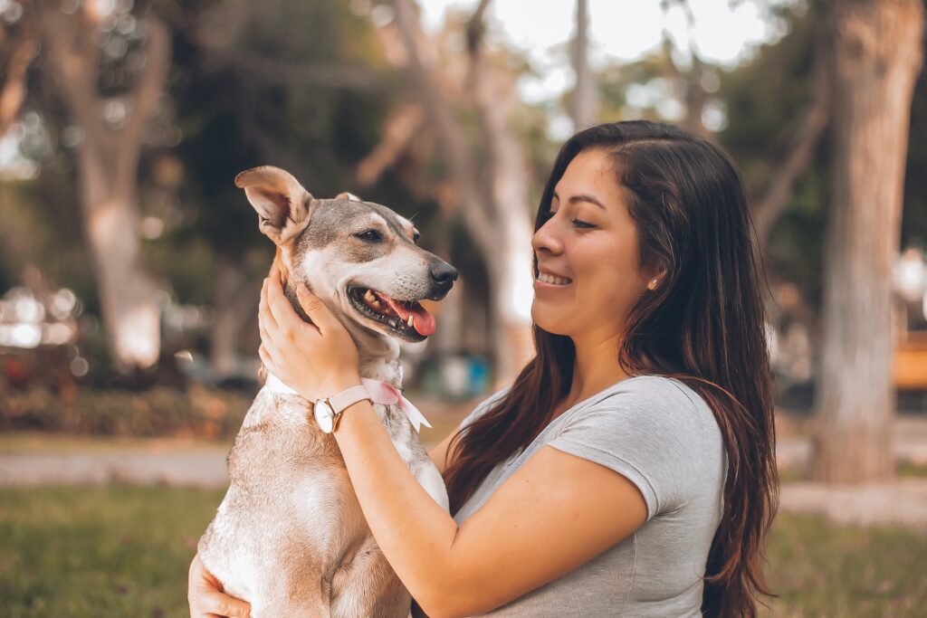 woman playing with dog